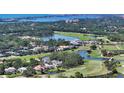 Beautiful aerial view of home on golf course, surrounded by lush landscaping and water views at 228 Saint James Park, Osprey, FL 34229