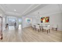 Dining room with marble table and white chairs, and natural light flowing into the space at 2450 Harbourside Dr # 233, Longboat Key, FL 34228