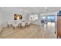 Bright dining room with modern light fixture, hardwood floors, and ocean views at 2450 Harbourside Dr # 233, Longboat Key, FL 34228