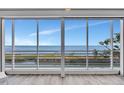 Breathtaking ocean view from interior window with light colored hardwood floors at 2450 Harbourside Dr # 233, Longboat Key, FL 34228