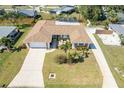 An attractive single-story home boasts a well-kept lawn, a screened-in pool, and a charming front patio at 259 Hammock Ter, Venice, FL 34293