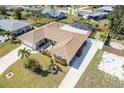 An appealing aerial shot shows a single-story house with a manicured lawn, an enclosed pool, and a relaxing front patio at 259 Hammock Ter, Venice, FL 34293