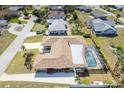 A lovely aerial view highlights a single-story home featuring a pool, well-kept yard and inviting front patio at 259 Hammock Ter, Venice, FL 34293