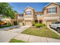 Inviting townhouse with attached garages, neutral stucco, red shutters and well-maintained landscaping at 2819 Conch Hollow Dr, Brandon, FL 33511