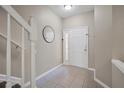 Bright foyer with tile flooring, fresh paint, updated hardware, and a staircase at 2819 Conch Hollow Dr, Brandon, FL 33511
