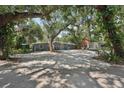 Charming single-story home features a large front yard and eye-catching blue exterior door at 2848 Trinidad St, Sarasota, FL 34231