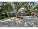 Charming single-story home features a large front yard and eye-catching blue exterior door at 2848 Trinidad St, Sarasota, FL 34231