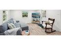 Cozy living room with wood floors, comfortable seating, and a serene view outside the window at 2848 Trinidad St, Sarasota, FL 34231