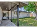 Inviting covered entryway with stone accents, leading to the front door and complemented by well-kept lawn at 3136 Webber St, Sarasota, FL 34239