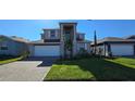 Charming two-story home boasts a manicured lawn and a paver driveway leading to an attached two-car garage at 3531 Night Star Ter, Parrish, FL 34219