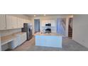 Bright open kitchen featuring white cabinetry, stainless appliances, and an island with a sink and breakfast bar seating at 3531 Night Star Ter, Parrish, FL 34219