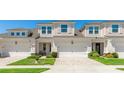 Inviting townhouse exterior with brick driveway, two-car garage, and manicured landscaping at 3684 Fescue Ln, Sarasota, FL 34232