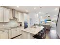 Modern kitchen with granite countertops, stainless steel appliances, and breakfast bar at 3684 Fescue Ln, Sarasota, FL 34232