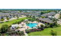 Aerial view of a community pool and lounge area with tropical landscaping and outdoor seating at 3684 Fescue Ln, Sarasota, FL 34232
