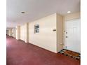 Hallway leading to the unit features a neutral color palette at 3730 Cadbury Cir # 631, Venice, FL 34293