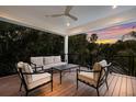 Outdoor living area with sunset views, comfortable seating, and a ceiling fan at 408 Magnolia Ave, Anna Maria, FL 34216