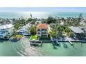 Beautiful waterfront home featuring a private boat dock, lush landscaping, and gulf views at 416 Casey Key Rd, Nokomis, FL 34275