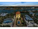 Expansive aerial view of a waterfront property, showcasing the serene neighborhood and canal access at 416 Casey Key Rd, Nokomis, FL 34275