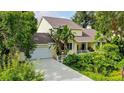 Beautiful home with a well-maintained lawn, mature trees and a driveway leading to an attached garage at 4326 Brackenwood Ct, Sarasota, FL 34232