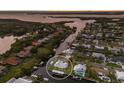 Aerial view of waterfront home showcasing its location among canals, and lush surroundings at 4517 Pinfish Ln, Palmetto, FL 34221