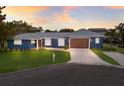 Charming single story home boasts of blue exterior, manicured lawn and attached two car garage at 4517 Pinfish Ln, Palmetto, FL 34221