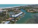 Aerial view of waterfront condo with a pool, boat slips and convenient beach access at 615 Dream Island Pl # 303, Longboat Key, FL 34228