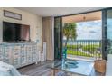 Comfortable condo living room with ocean views and lanai access at 6480 Midnight Pass Rd # 316, Sarasota, FL 34242