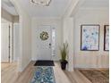 Bright foyer featuring a decorative rug, a glass-accented front door, and stylish decor at 7044 Whittlebury Trl, Bradenton, FL 34202