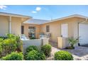 Cozy patio area with brick pavers, lush landscaping, and outdoor seating, perfect for relaxing at 7069 W Country Club N Dr # 7069, Sarasota, FL 34243