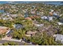 An aerial view showcases this homes waterfront community, lush landscaping, and location near the water at 717 Treasure Boat Way, Sarasota, FL 34242