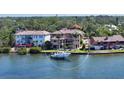 Waterfront home with a private dock, boat lift, manicured lawn and mature landscaping at 7342 Captain Kidd Ave, Sarasota, FL 34231