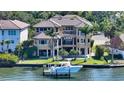 Beautiful view of backyard with boat dock, lush landscaping, and room for entertaining at 7342 Captain Kidd Ave, Sarasota, FL 34231