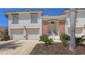 Inviting two-story building showcasing a well-manicured lawn, covered entry, and two-car garage at 7632 Marsh Orchid Cir # 7632, Bradenton, FL 34203