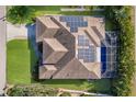 Aerial view of a home featuring a pool, solar panels, and well-maintained landscaping at 8314 9Th Avenue Nw Ter, Bradenton, FL 34209