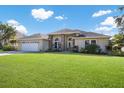 Inviting home with a well-manicured lawn, a two-car garage and an elegant arched entryway at 8314 9Th Avenue Nw Ter, Bradenton, FL 34209