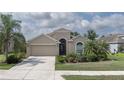 Charming single-Gathering home features a two-car garage, complemented by mature landscaping and a well-manicured lawn at 11319 82Nd E St, Parrish, FL 34219