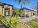 Inviting home exterior with manicured landscaping and a charming front entrance at 13644 Brilliante Dr, Venice, FL 34293