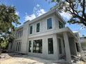 Modern home under construction featuring a sleek exterior and large windows at 1423 S Shade Ave, Sarasota, FL 34239