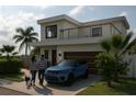 Modern two-story home with a balcony, garage, and well-manicured front lawn at 1423 S Shade Ave, Sarasota, FL 34239