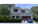 Rendering of a modern two-story home with a balcony, garage, and landscaped front yard at 1423 S Shade Ave, Sarasota, FL 34239