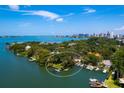 Waterfront home on peninsula surrounded by lush landscaping, private dock, and ocean access at 1542 Gulfview Dr, Sarasota, FL 34236