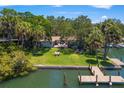 Waterfront home with lush grassy yard, private dock, and outdoor seating area, perfect for entertaining at 1542 Gulfview Dr, Sarasota, FL 34236