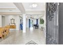 Spacious foyer boasting neutral tile, a grand piano, and elegant decor, bathed in natural light at 17003 2Nd E Ave, Bradenton, FL 34212