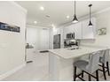 Stylish kitchen with white cabinets, stainless steel appliances, and center island with seating at 17640 Northwood Pl, Bradenton, FL 34202