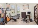 Well-lit home office with built-in bookshelves and large windows at 17640 Northwood Pl, Bradenton, FL 34202