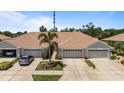 Aerial view of homes with tile roofs, paved driveways, and well-maintained landscaping at 1951 San Silvestro Dr, Venice, FL 34285