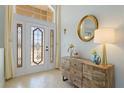 Bright entryway showcases decorative glass door and tile flooring, complemented by stylish furniture and decor at 22324 Wexford Blvd, Venice, FL 34293