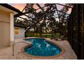 Private screened pool area with brick pavers, lounge chairs, and views of a lush backyard at 2309 Chardonnay Ter, Parrish, FL 34219