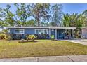 Charming home featuring well-manicured lawn and covered front porch at 2350 Novus St, Sarasota, FL 34237