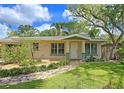 Lovely home featuring a well-maintained lawn, lush landscaping, and a stone walkway at 3004 Bay Shore Cir, Sarasota, FL 34234